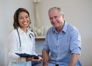 female doctor and senior man smiling