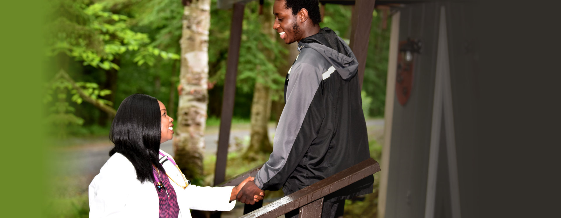 female doctor handshaking with an adult man smiling