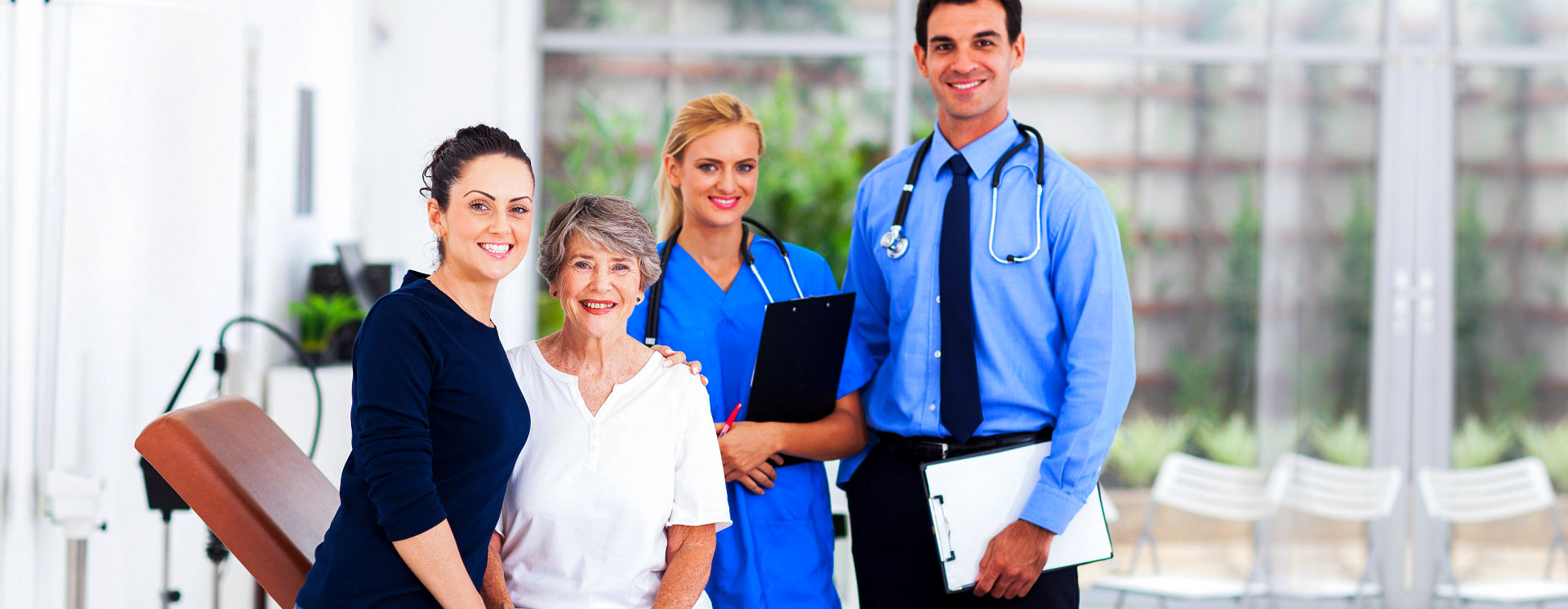 male doctor and female nurse with senior and adult woman smiling