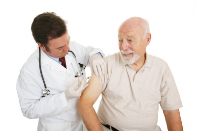 senior man getting a shot from a doctor